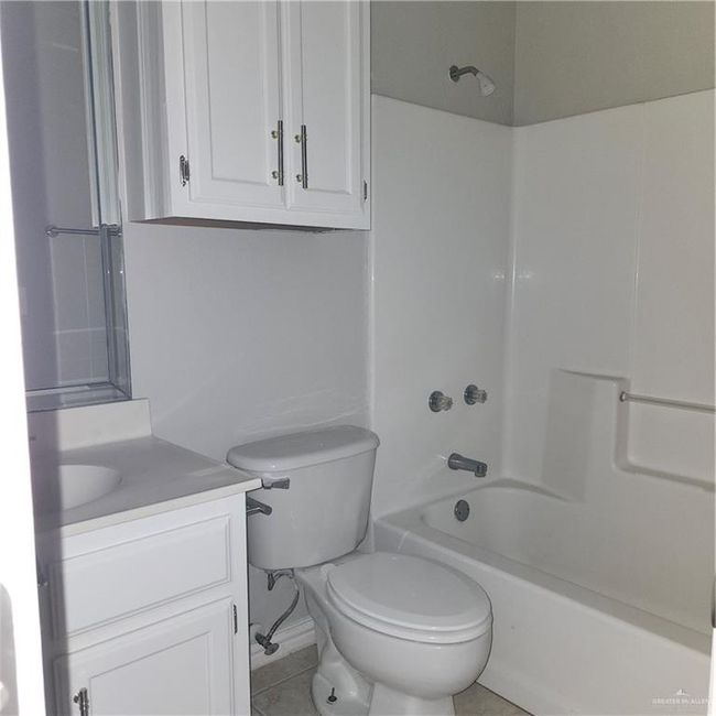 Bathroom featuring vanity and tub / shower combination | Image 7