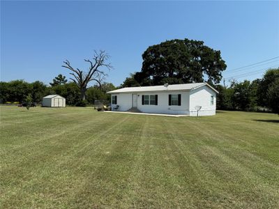 View of front of property featuring a storage shed and a front lawn | Image 1