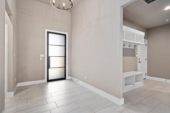 Mudroom with a chandelier and baseboards | Image 8