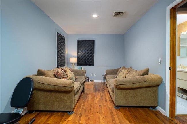 Living area with wood finished floors and recessed lighting | Image 10