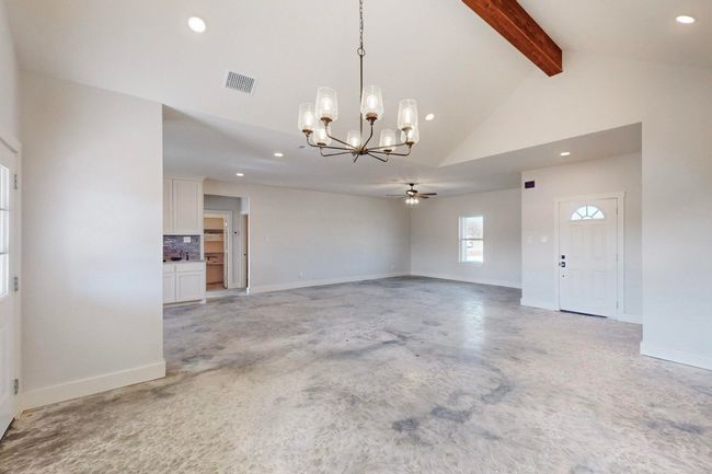 Empty room featuring recessed lighting, visible vents, baseboards, and vaulted ceiling with beams | Image 8