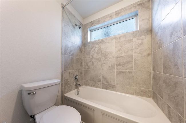 Full bathroom featuring toilet and shower / tub combination | Image 14