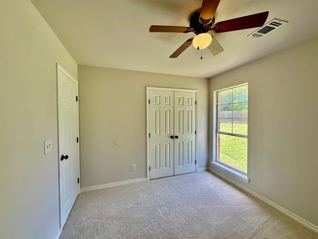 Unfurnished bedroom featuring carpet floors, a closet, and ceiling fan | Image 15