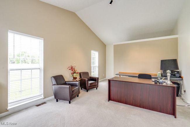 Office with light colored carpet and high vaulted ceiling | Image 19