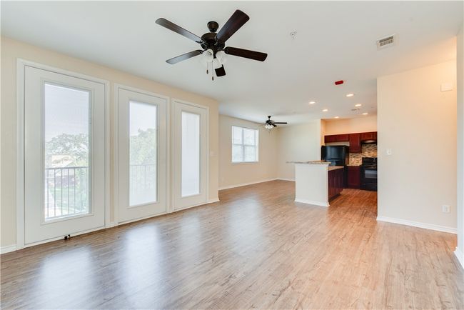 Unfurnished living room with recessed lighting, visible vents, a ceiling fan, light wood-style floors, and baseboards | Image 6