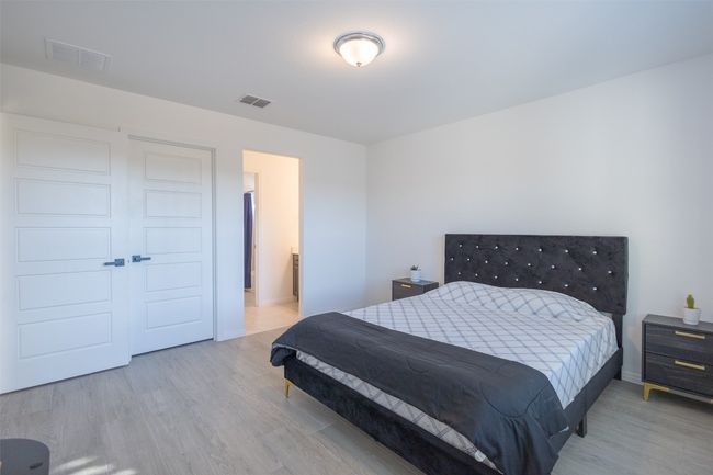 This bedroom has high ceilings and tile flooring throughout. | Image 24