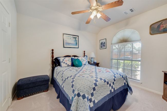 Bedroom featuring light carpet, baseboards, a ceiling fan, and lofted ceiling | Image 27