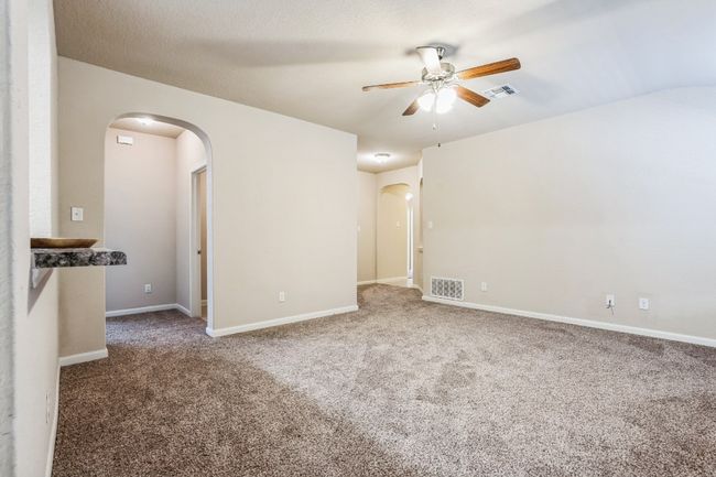 Unfurnished room featuring ceiling fan and carpet flooring | Image 6