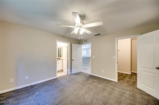 Unfurnished bedroom with ceiling fan, carpet floors, visible vents, and baseboards | Image 30