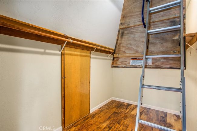 primary bedroom closet with finished attic access | Image 28