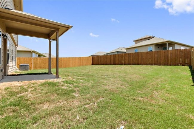 View of yard featuring central AC unit and a patio area | Image 23