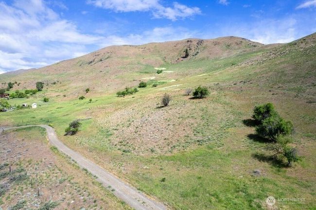 Simple dirt gravel driveway takes you on the property and shared with neighbor beyond the 7.33 Acres to the East. | Image 25