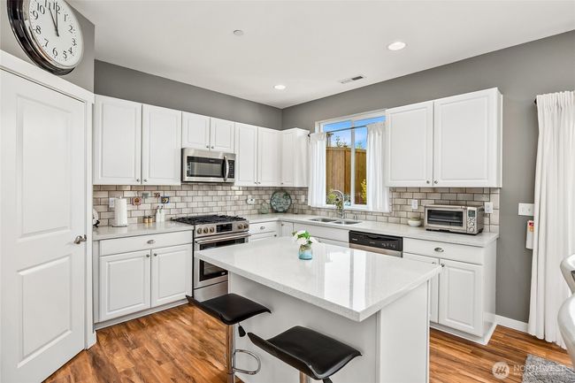 Kitchen has plenty of counter top space and an abundance of cabinetry | Image 14