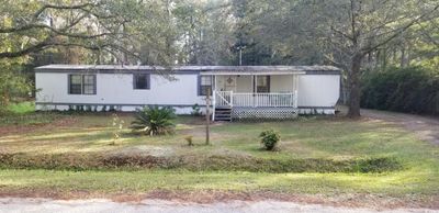 Manufactured / mobile home with a front lawn and covered porch | Image 1