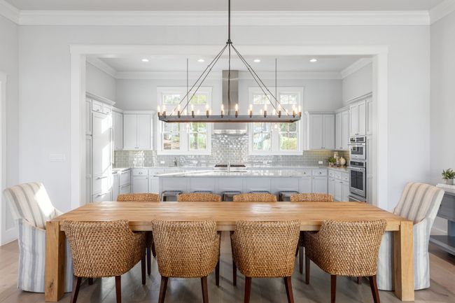 Dining room featuring a notable chandelier, light wood-style flooring, and ornamental molding | Image 12