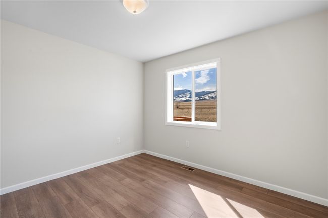 Empty room with baseboards, visible vents, and wood finished floors | Image 54