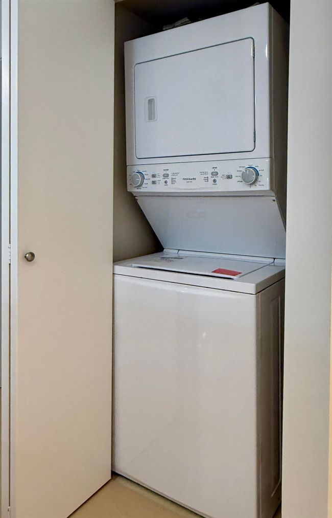 Washroom featuring stacked washer and clothes dryer | Image 13