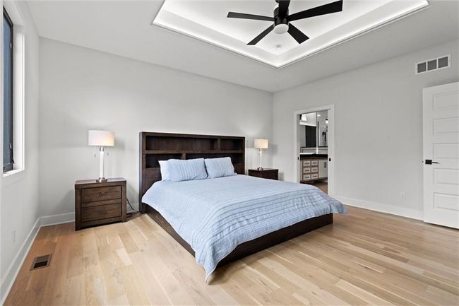 Bedroom with light wood-style floors, a ceiling fan, and ensuite bathroom | Image 19