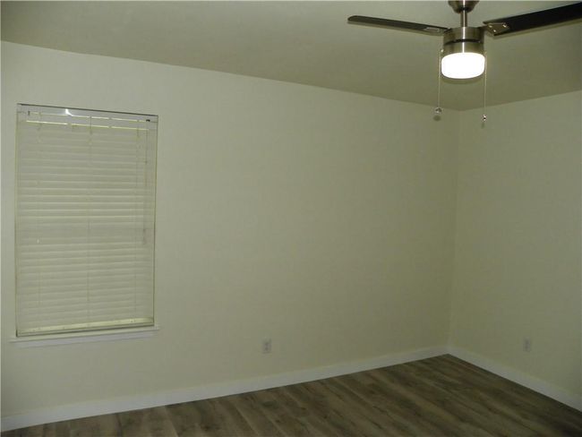 Spare room with wood finished floors and a ceiling fan | Image 18