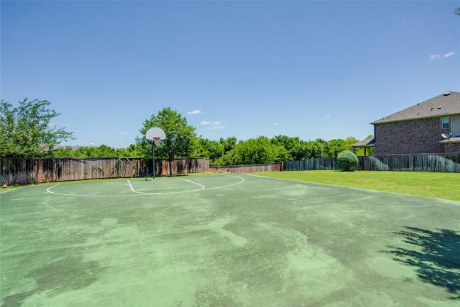 View of sport court with community basketball court and a fenced backyard | Image 28