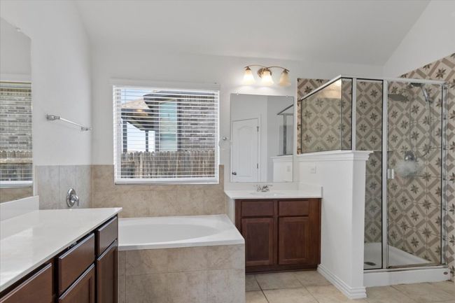 Full bath with a shower stall, a bath, tile patterned flooring, and vanity | Image 16