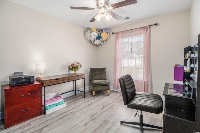 Home office featuring wood finished floors, ceiling fan, and baseboards | Image 17