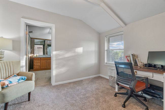 Office space featuring vaulted ceiling and light colored carpet | Image 28