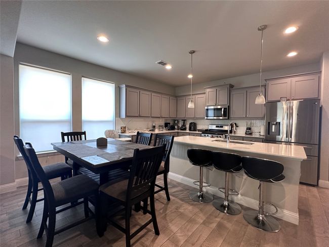 Dining room featuring wood finished floors and recessed lighting | Image 9