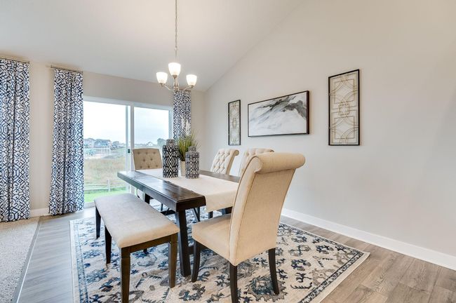 Another highlight to the home, the dining space is over 15-feet deep and coated in the same hard surface flooring that covers most of the main level. Photo of model, colors and options will vary. | Image 7