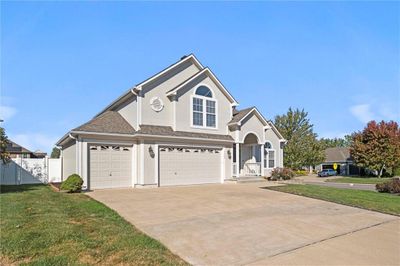 View of front property with a front yard and a garage | Image 3