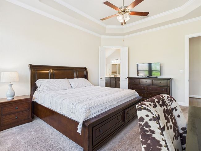 Bedroom featuring carpet floors, ensuite bathroom, and visible vents | Image 12