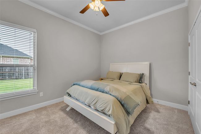 Carpeted bedroom featuring crown molding, baseboards, and ceiling fan | Image 31