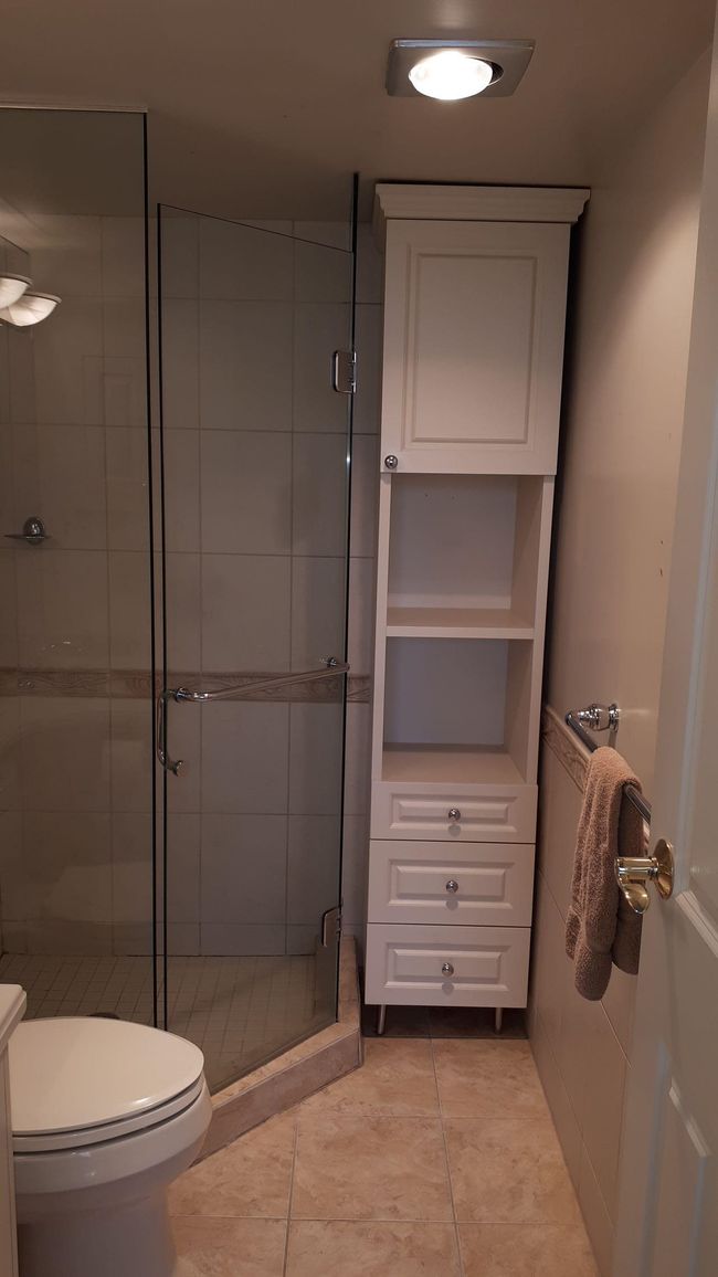 Full bathroom featuring tile patterned floors, toilet, and a stall shower | Image 5