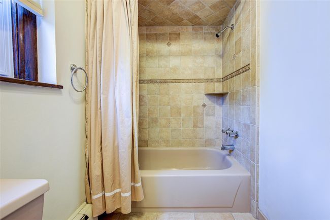 Bathroom featuring shower / tub combo with curtain and toilet | Image 32