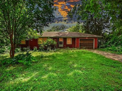 Single story home featuring a lawn and a garage | Image 2