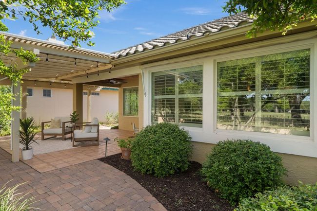 Patio with a pergola and well maintained yard. | Image 15