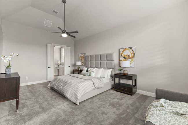 Carpeted primary bedroom with high vaulted ceiling, ceiling fan, sitting area and connected bathroom | Image 21