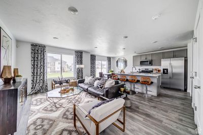 Living room with hardwood / wood-style flooring and sink | Image 2