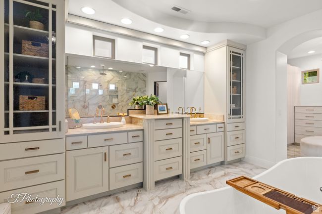 Bathroom with marble look tile flooring, vanity, a soaking tub, recessed lighting, and a walk in shower | Image 29