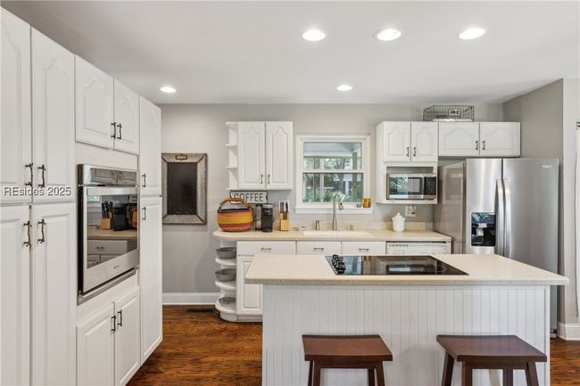 Updated chef's kitchen with stainless steel appliances & ample storage, efficient flow and a window over the sink for a view while prepping and cooking. | Image 16