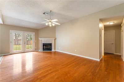 Living room with hard wood floors and gas fireplace | Image 2