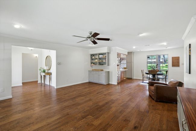 Living room featuring ornamental molding, a ceiling fan, dark wood-style floors, and recessed lighting | Image 8