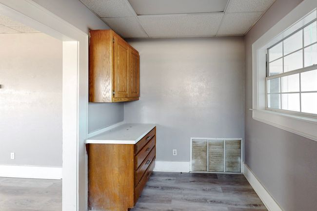 Bar with a drop ceiling and hardwood / wood-style floors | Image 26