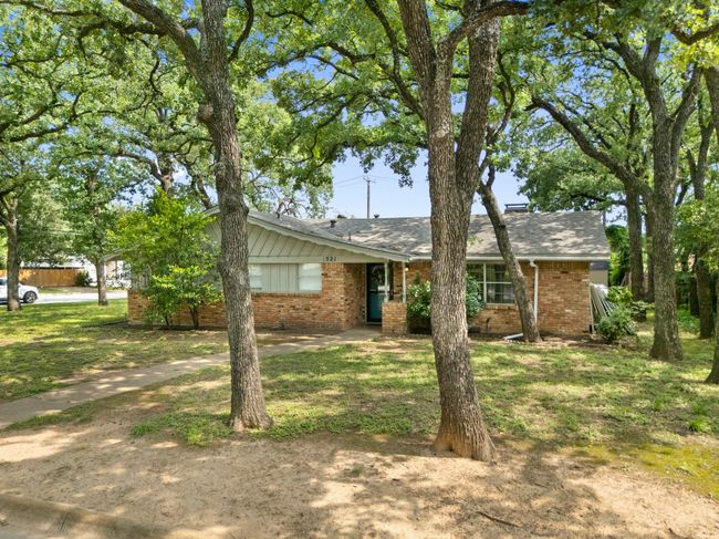 View of front of property featuring brick siding, a front yard, and a shingled roof | Image 35