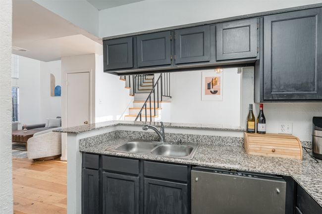 Kitchen with dishwashing machine, a sink, and light wood-type flooring | Image 10