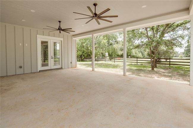 View of patio featuring a ceiling fan and french doors | Image 22