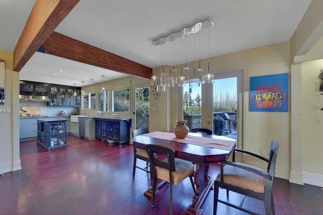 Dining room featuring dark wood-style floors, healthy amount of natural light, and beamed ceiling | Image 11