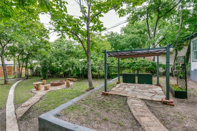Fenced backyard with a fire pit and a patio area | Image 20