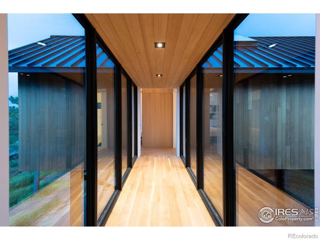 Main level private sanctuary accessed via an architecturally stunning elevated glass walkway, Marvin black-clad floor-to-ceiling windows | Image 18