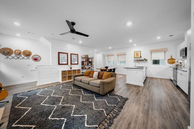 Living room with a ceiling fan, dark wood-type flooring, baseboards, and recessed lighting | Image 6